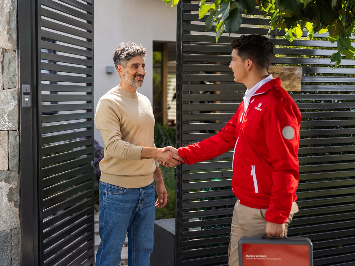 Verisure technician greeting a homeowner at the front gate.