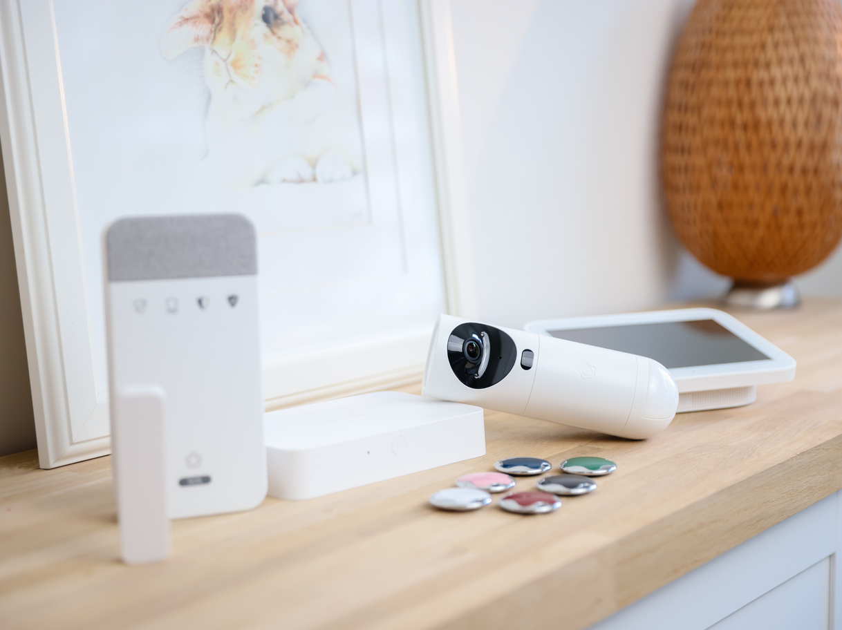 Verisure alarm system components displayed on a wooden shelf.