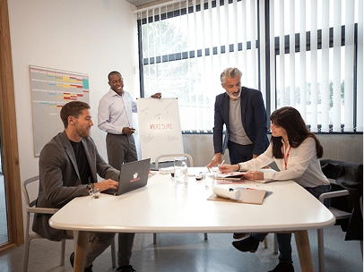 Verisure colleagues working together during a team meeting in an office environment.
