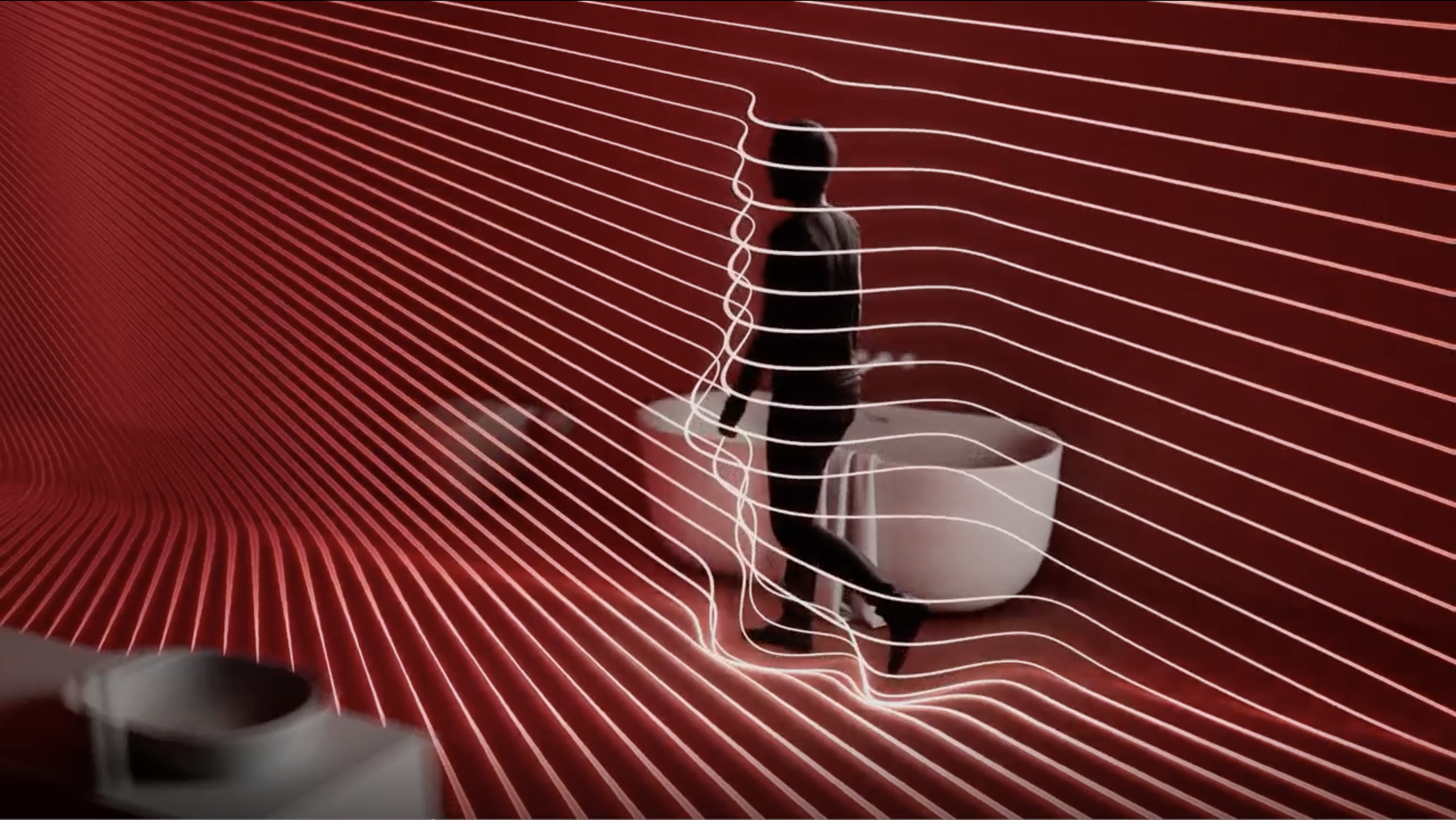 Person walking through flowing digital lines in a red immersive space